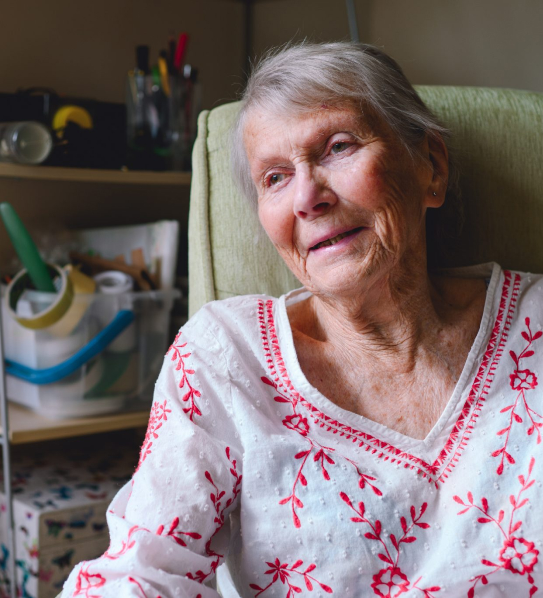 Elderly woman sitting comfortably at home in Brighton and Hove enjoying a peaceful moment.